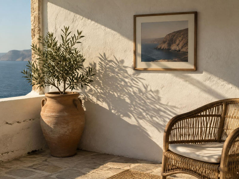 Sunlit Mediterranean corner with a framed coastal print