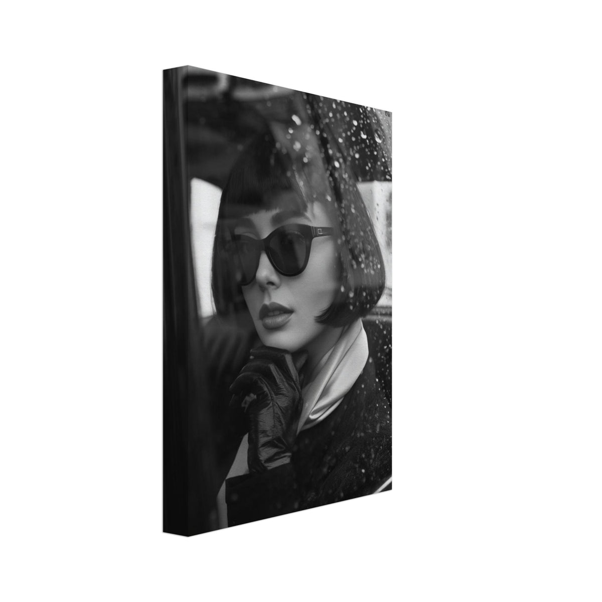 Woman with a bob haircut, sunglasses and a gloved hand beneath her chin, seen through a rain-speckled car window.