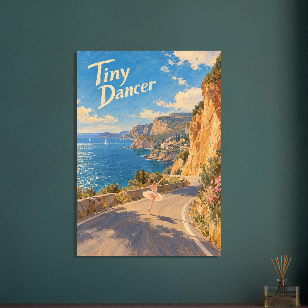 Ballerina dancing on a coastal road beside golden cliffs and blue sea, with cream “Tiny Dancer” lettering in the sky.