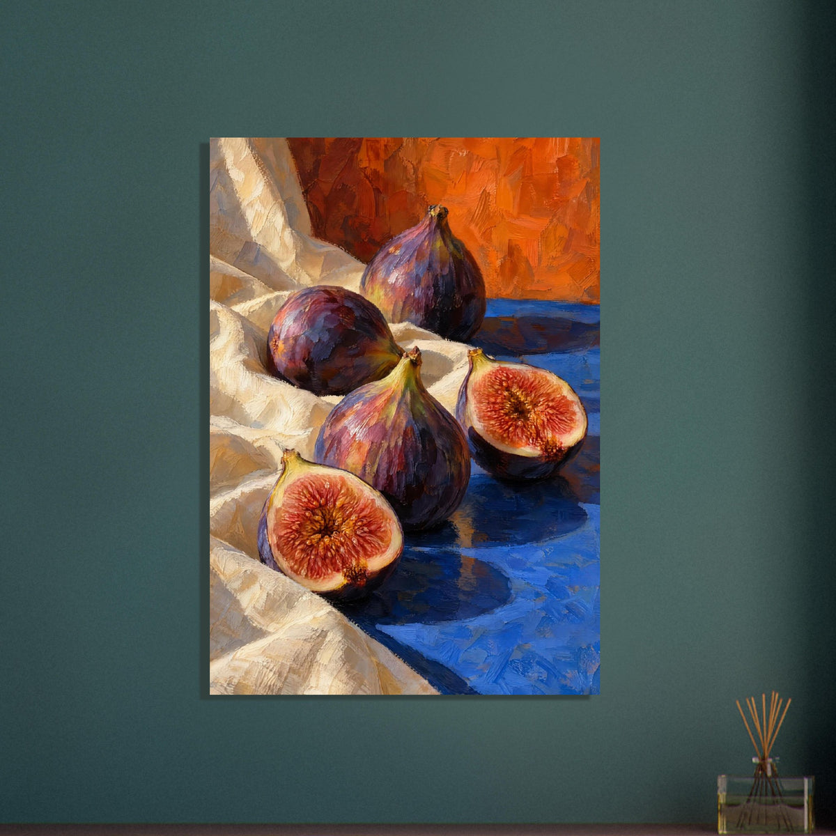 Three whole purple figs and two cut halves on cream fabric and a blue surface, with an orange background and textured brushwo