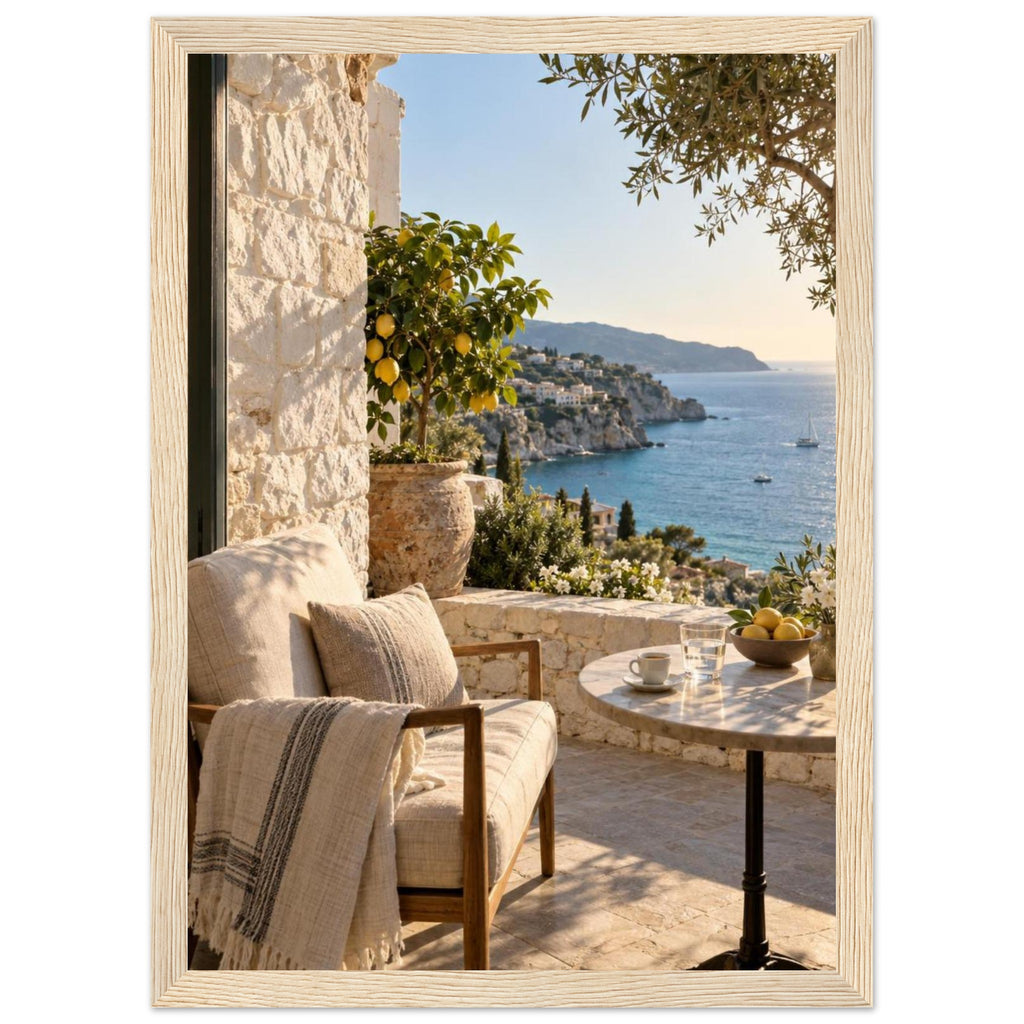 Lemon tree on a stone terrace with a cushioned chair, round table and blue sea overlooking a rocky coastline.