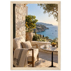 Lemon tree on a stone terrace with a cushioned chair, round table and blue sea overlooking a rocky coastline.