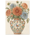 Terracotta and blue dahlias with green leaves in a two-handled vase decorated with flowers and a bird on cream.