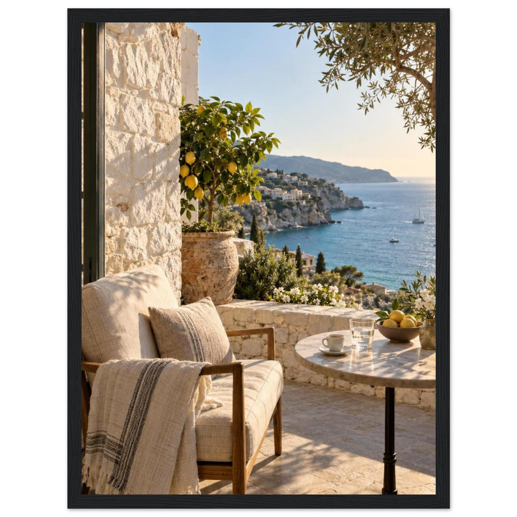 Lemon tree on a stone terrace with a cushioned chair, round table and blue sea overlooking a rocky coastline.