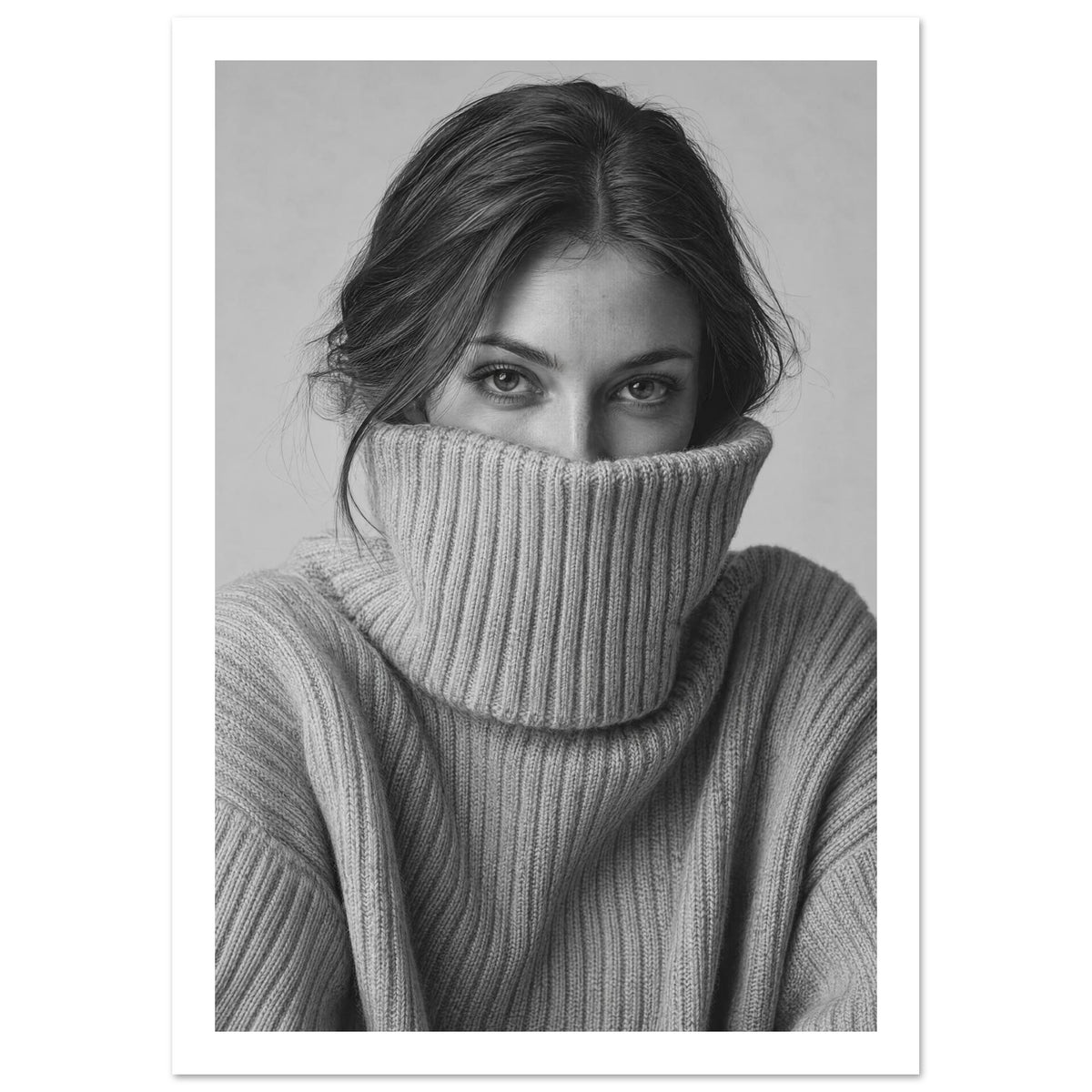 Woman with dark hair looking directly ahead, her ribbed jumper pulled over her mouth, in a black and white portrait.