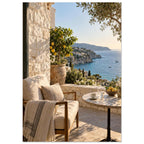 Lemon tree on a stone terrace with a cushioned chair, round table and blue sea overlooking a rocky coastline.