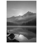 Mountain peaks and conifer forests reflected in a misty lake, with rocks in the foreground, in black and white.