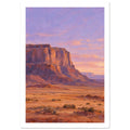 Terracotta desert cliffs above a scrub-covered plain, with distant mesas beneath a lilac and peach sky.