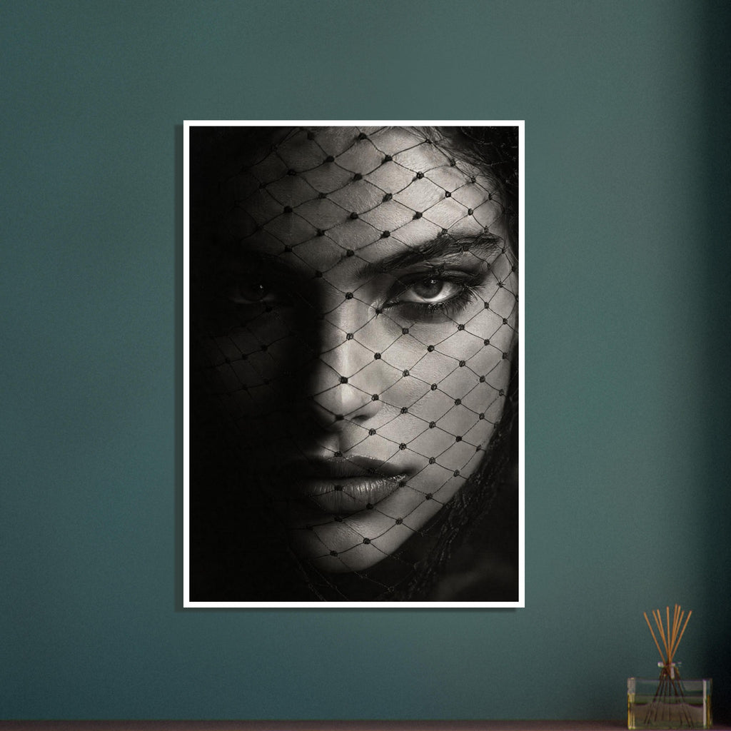 Woman's face behind a diamond-patterned net veil, with one eye brightly lit and the other in deep shadow, in black and white.