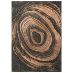 Irregular copper-toned concentric rings with distressed edges surrounding a dark centre on a textured charcoal background.