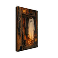 Open wooden cupboard with a ghost costume, witch’s hat, glowing pumpkin and lanterns, with a black cat sitting in front.
