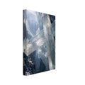 Giant translucent crystals cross a dark rocky cavern, with light entering above and a small figure standing on a ledge.