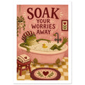 Frog in a shower cap relaxing in a pink bubble bath beneath ‘Soak Your Worries Away’ lettering, with a yellow bath duck.