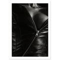 Black and white close-up of an open leather jacket with a diagonal metal zip and an exposed neckline.