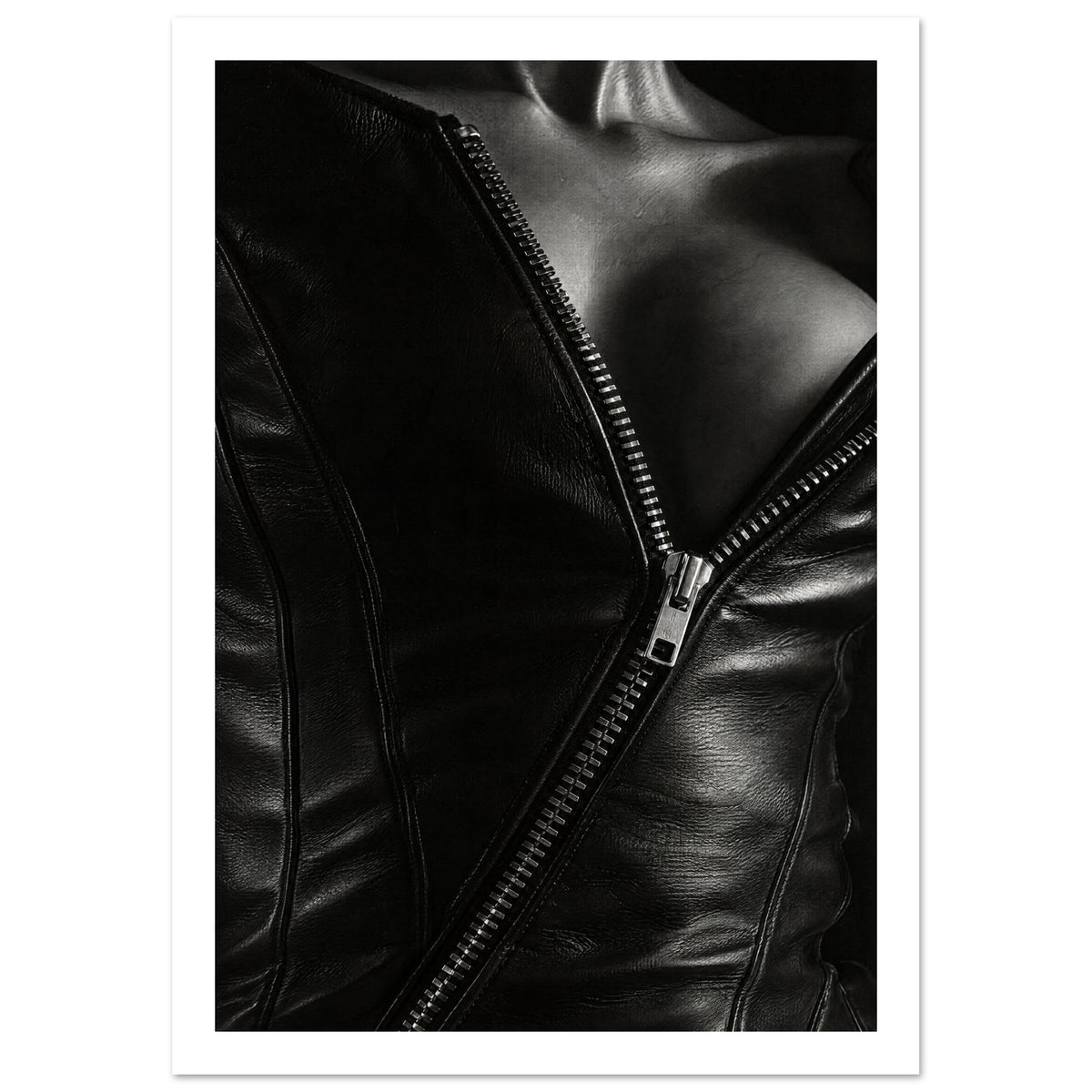 Black and white close-up of an open leather jacket with a diagonal metal zip and an exposed neckline.