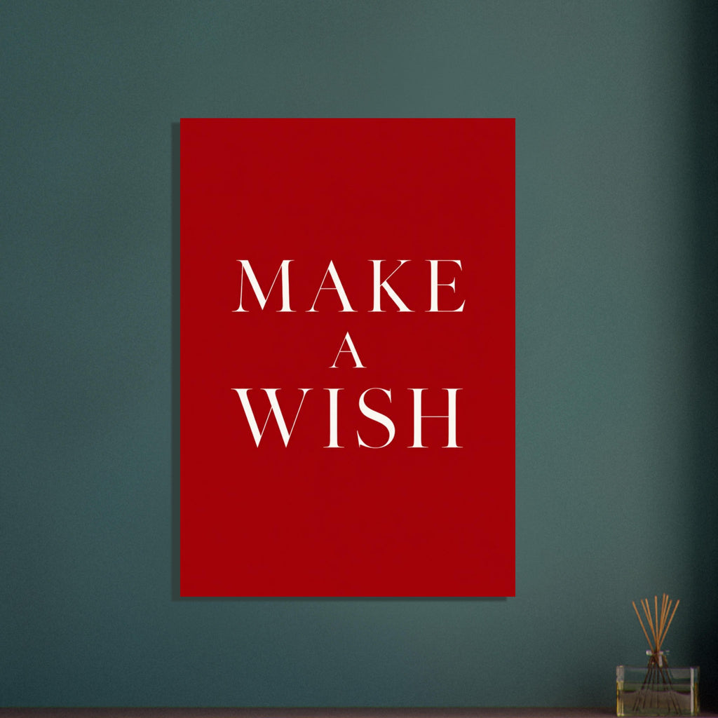Make a wish in large cream serif capitals, arranged across three centred lines on a deep red background.