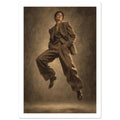 Suit in Suspension, a full-length model caught mid-jump in an oversized brown trouser suit against a sand-toned studio backgr