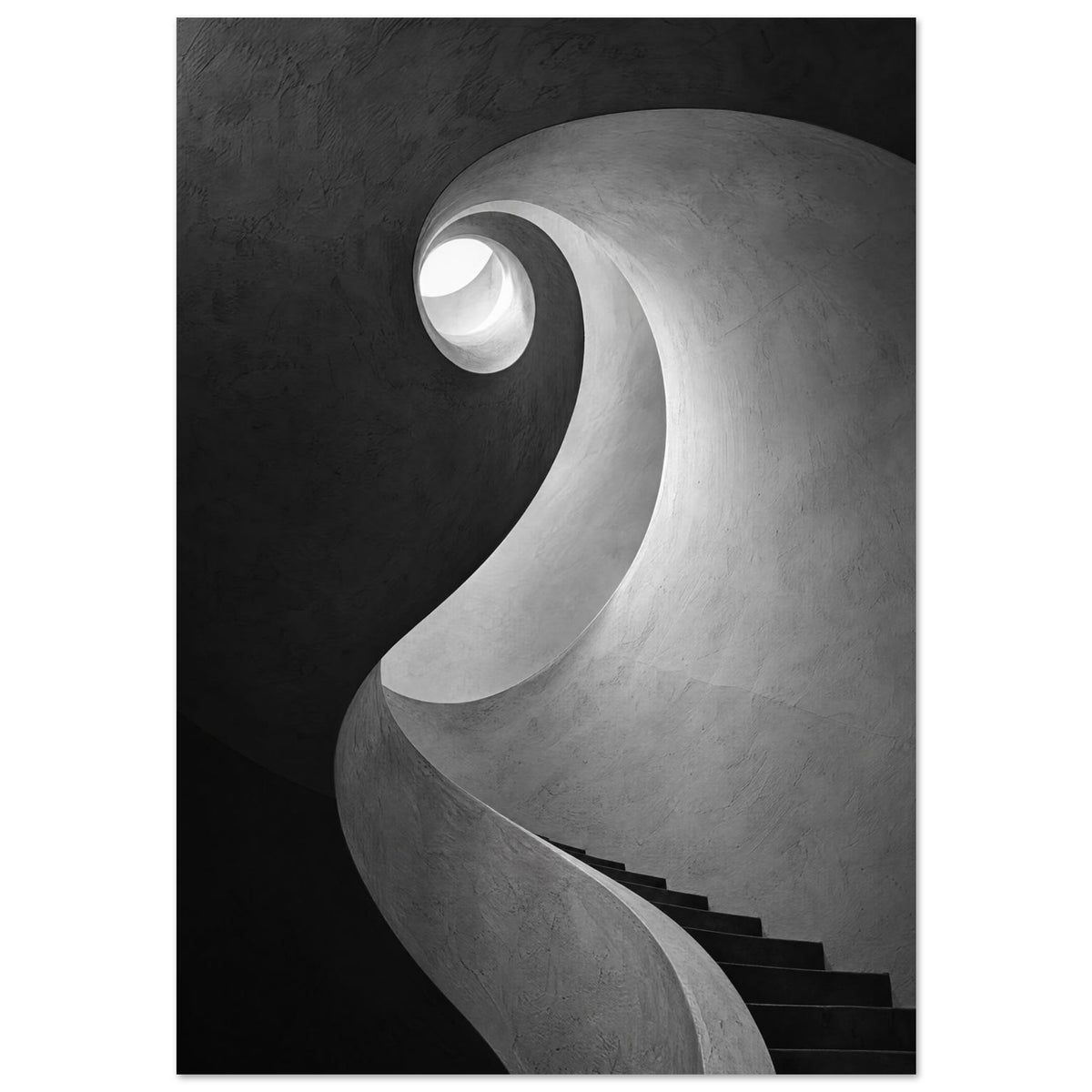 Spiral staircase viewed from below, with curved textured walls, dark steps and a bright opening in black and white.