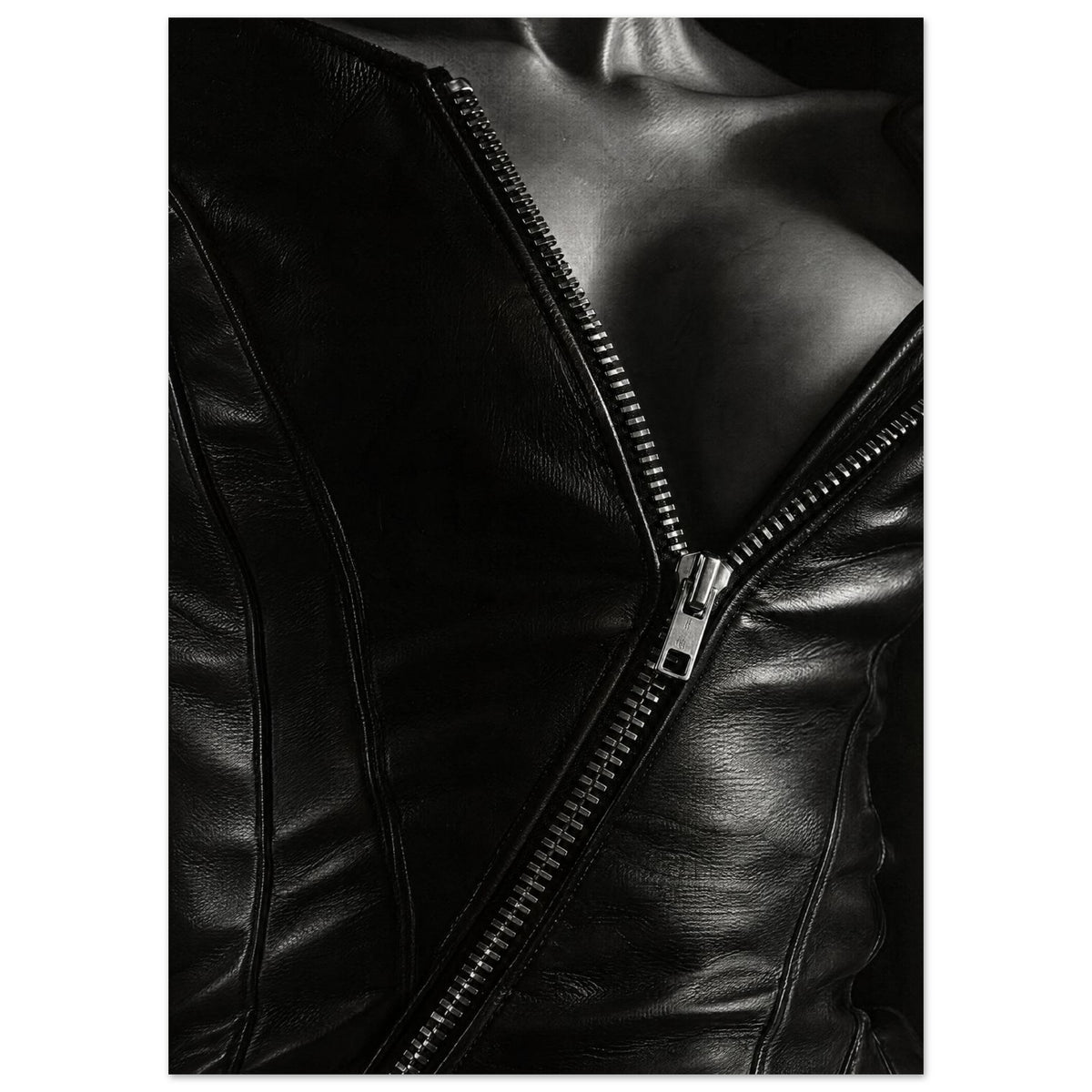 Black and white close-up of an open leather jacket with a diagonal metal zip and an exposed neckline.