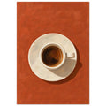 Espresso in a cream cup and saucer, viewed from above on a textured terracotta background with a dark cast shadow.