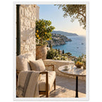 Lemon tree on a stone terrace with a cushioned chair, round table and blue sea overlooking a rocky coastline.