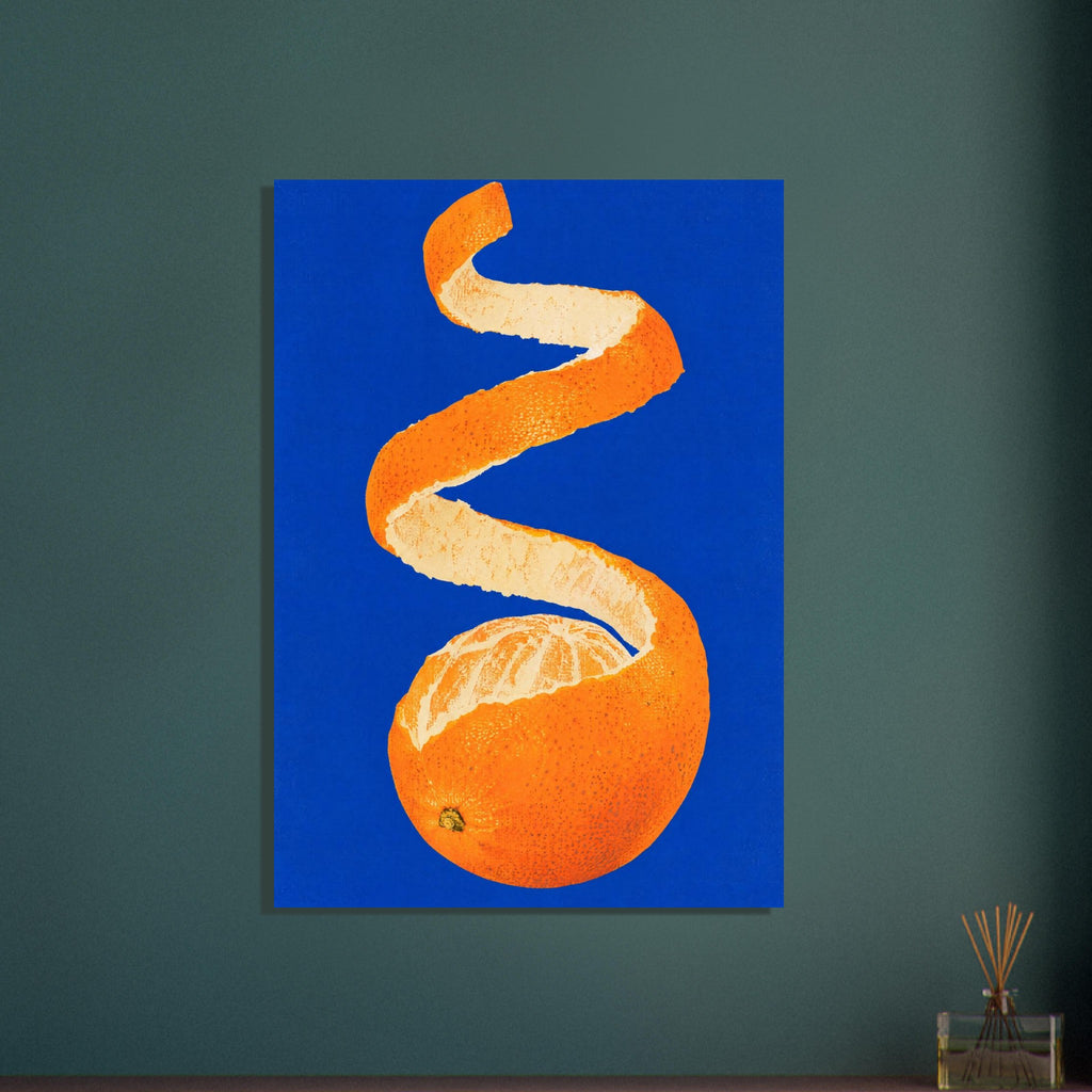Partly peeled orange with a long spiral of orange rind and cream pith against a vivid cobalt-blue background.