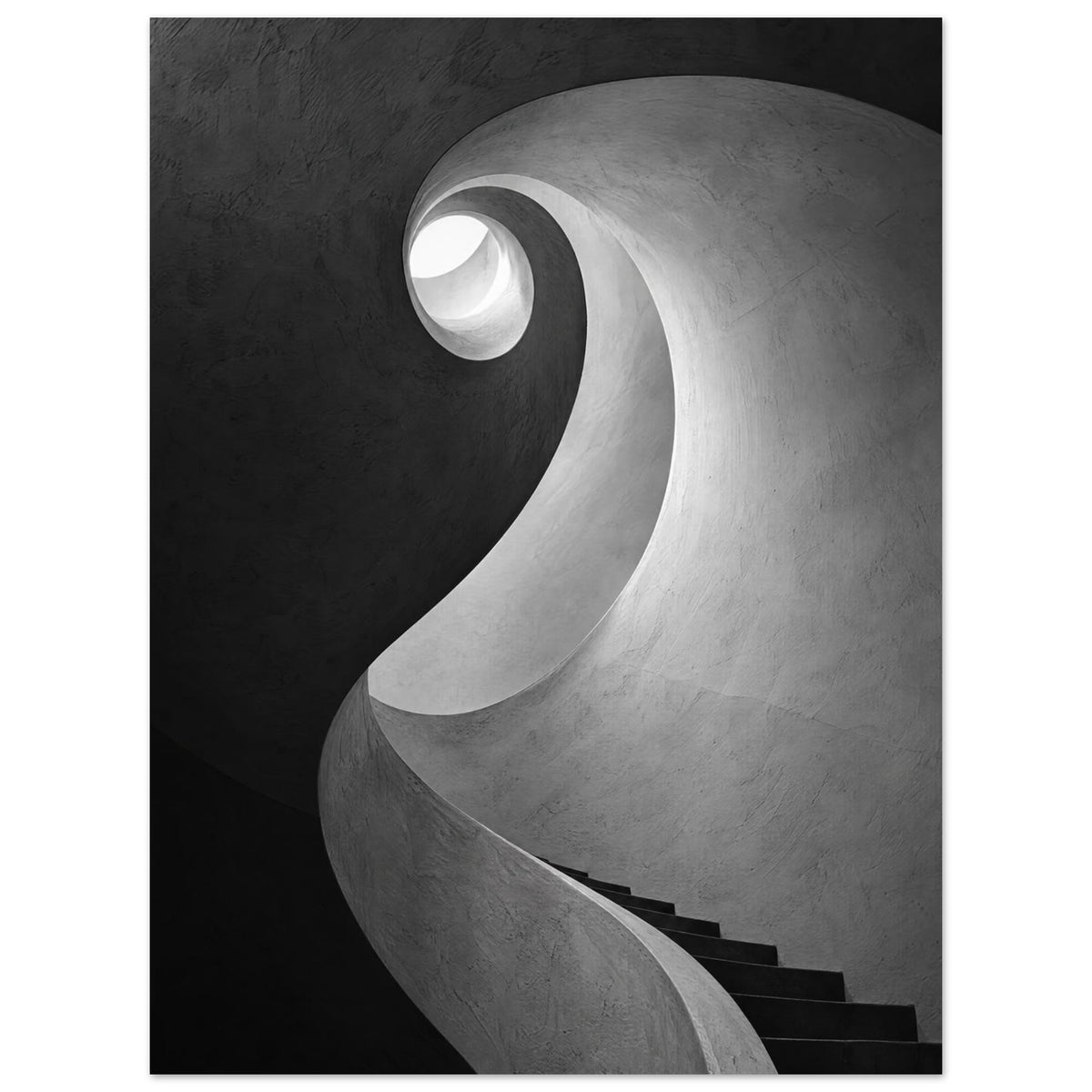 Spiral staircase viewed from below, with curved textured walls, dark steps and a bright opening in black and white.