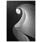 Spiral staircase viewed from below, with curved textured walls, dark steps and a bright opening in black and white.