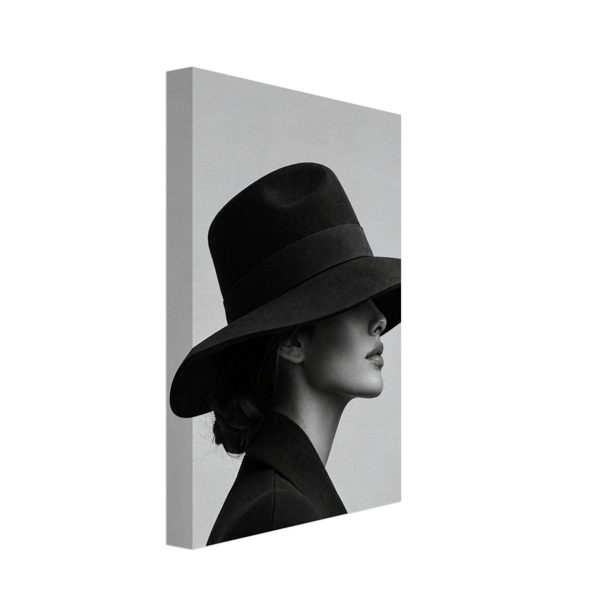 Woman in profile wearing a wide-brimmed black hat that covers her eyes and a dark coat against a plain grey background.