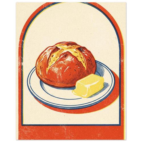 Round loaf and yellow butter on a blue-rimmed plate, with an orange-red arch border and textured cream background.