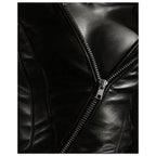 Black and white close-up of an open leather jacket with a diagonal metal zip and an exposed neckline.