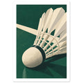 Vit fjäderboll på sidan i närbild på en skogsgrön badmintonbana med en vit linje bakom.