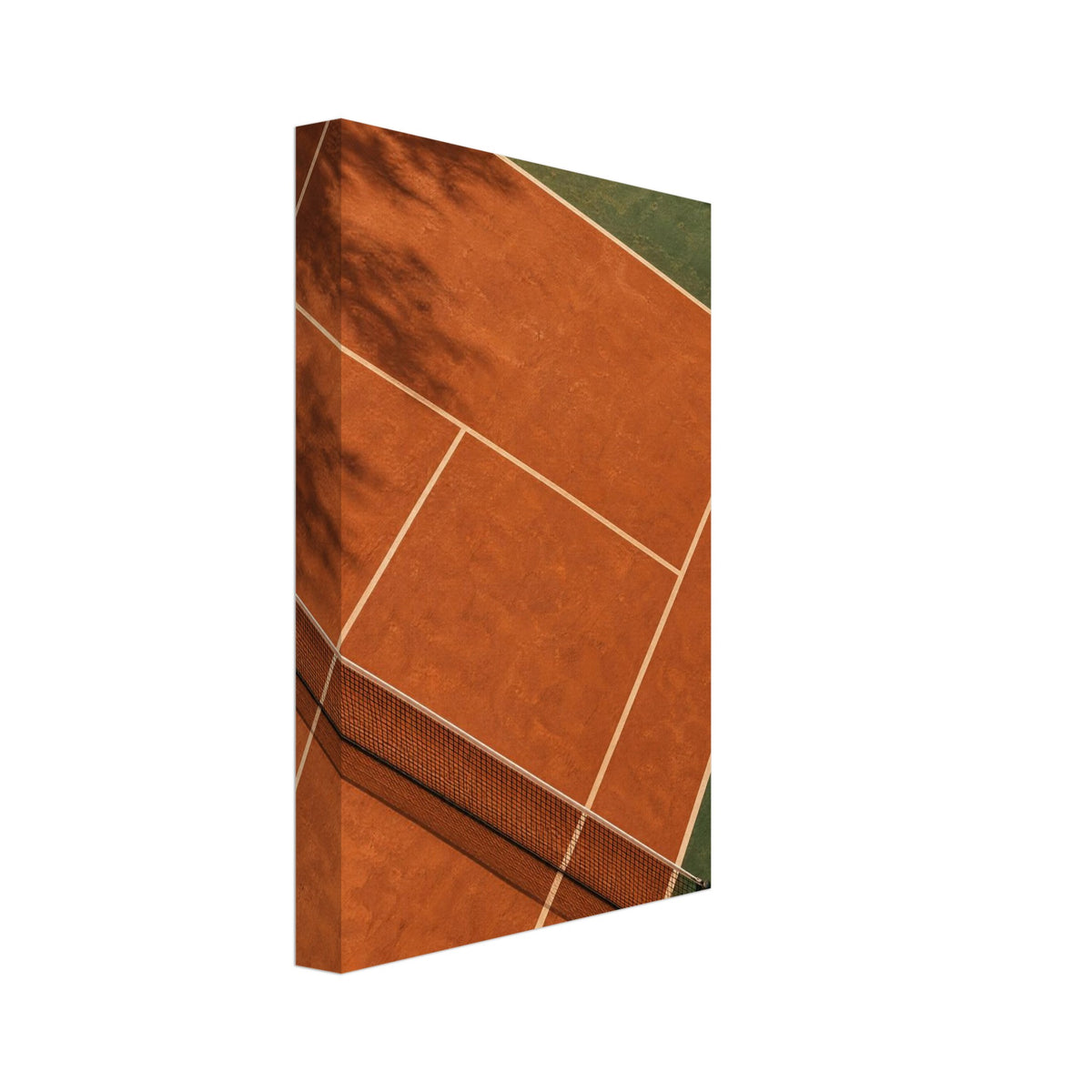 Terracotta tennis court viewed from above, with green surrounds, pale lines, a dark net and tree shadows.