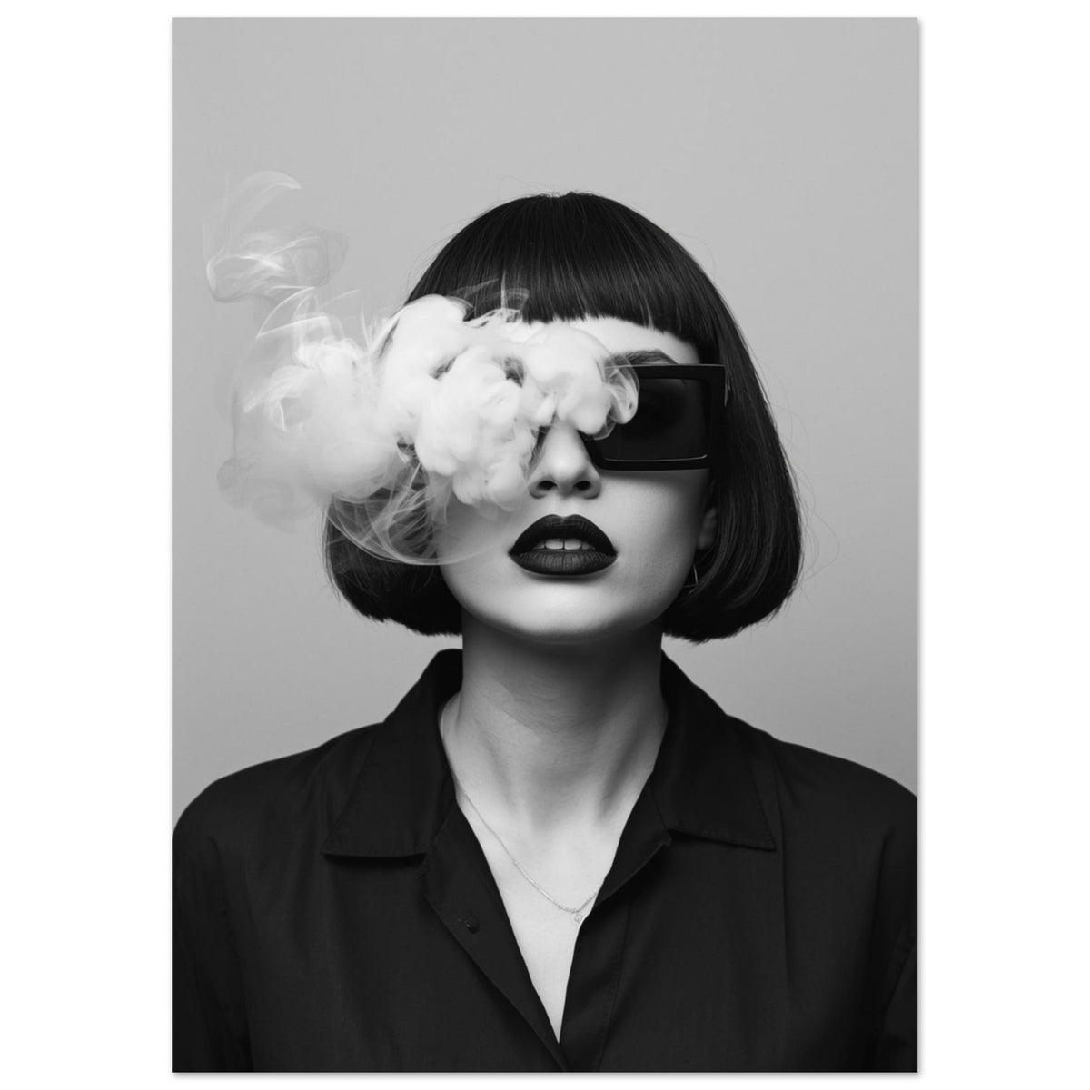 Woman with a dark bob, oversized sunglasses and dark lips, with smoke across her face in a black and white portrait.