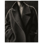 The Oversized Lapel, a chin-to-hip photograph of a model in a wool coat with a brightly outlined shoulder against charcoal sh