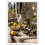 Lemons, olives, figs and a bottle of oil on a stone table beside a ceramic jug of leafy branches and a sunlit window.