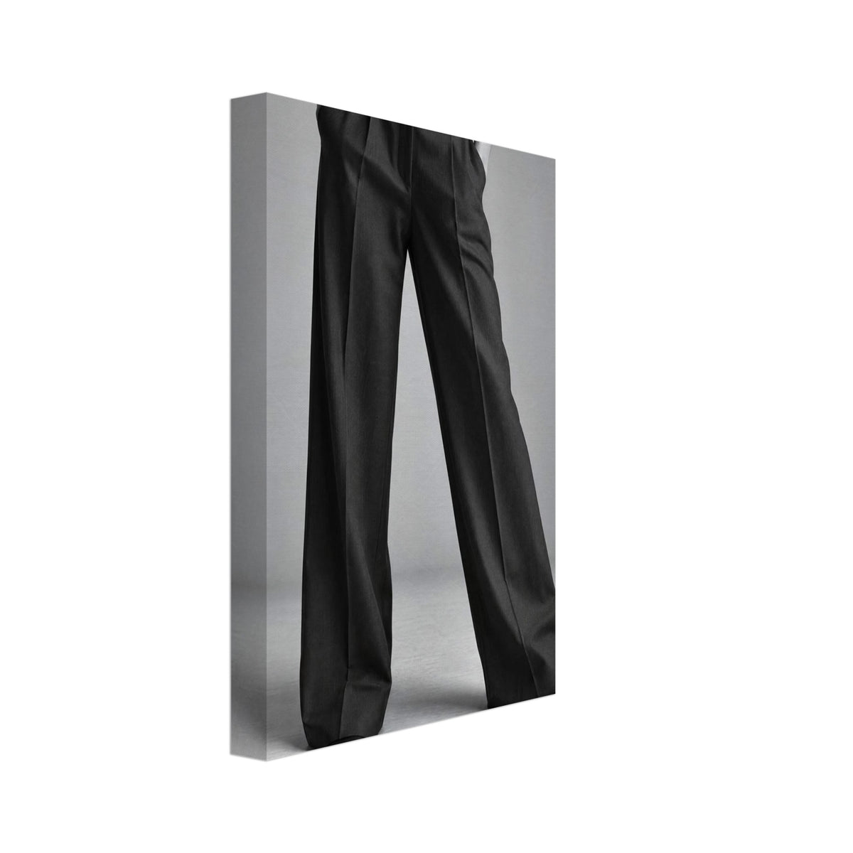Cropped figure in dark wide-leg trousers, a white ribbed top and pointed shoes, standing with hands in pockets.