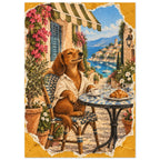 Brown dog in a cream shirt at a café table with coffee and a croissant, overlooking boats and a coastal village.
