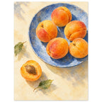 Apricots on a blue plate painted in watercolour, with a halved fruit beside the plate on a buttery cream tabletop.