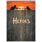Two silhouetted figures reaching towards each other at sunset above a cracked grey wall bearing the word ‘Heroes’.