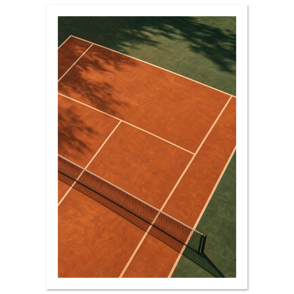 Terracotta tennis court viewed from above, with green surrounds, pale lines, a dark net and tree shadows.