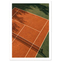 Terracotta tennis court viewed from above, with green surrounds, pale lines, a dark net and tree shadows.