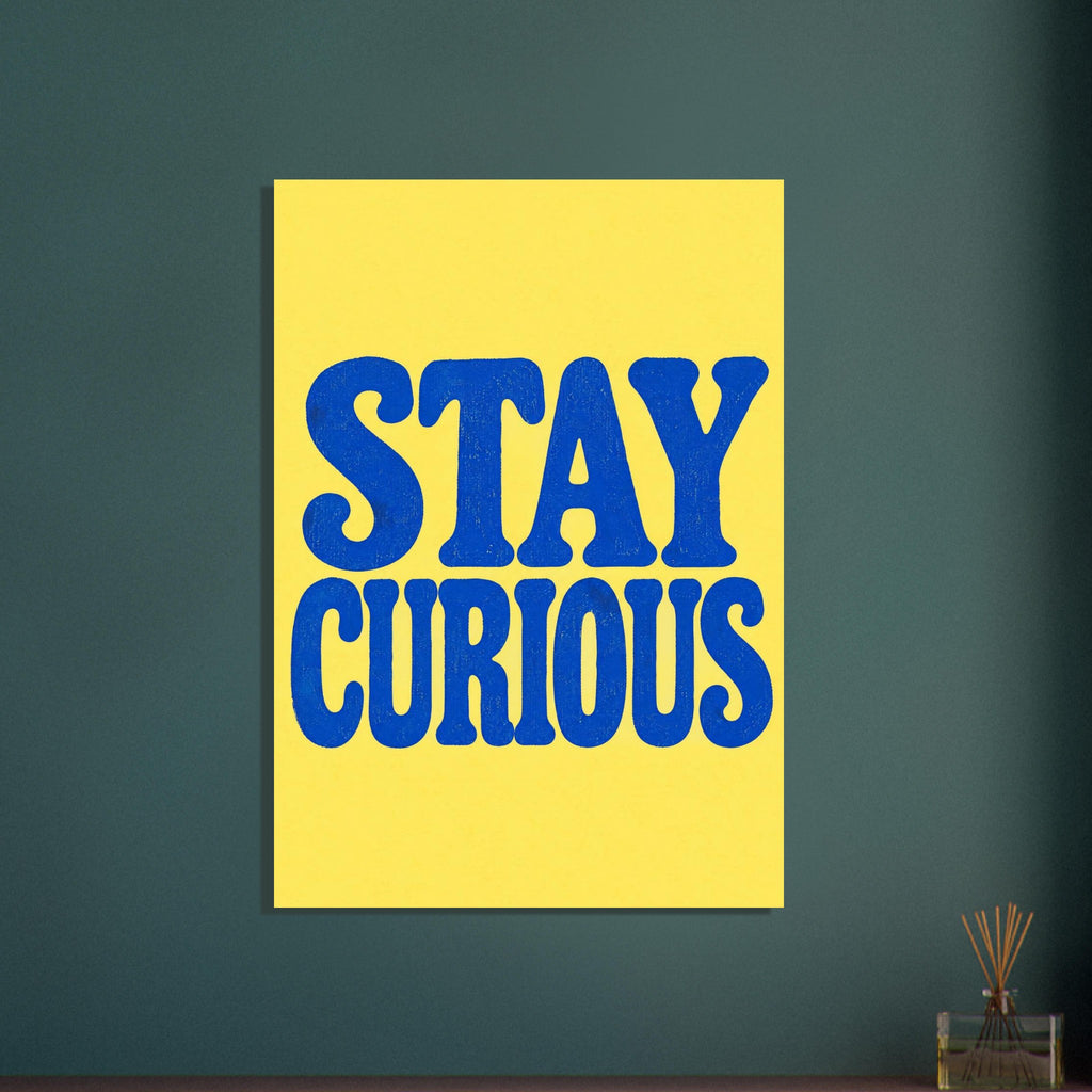 Stay Curious in large, textured blue retro lettering on two lines against a bright yellow background.