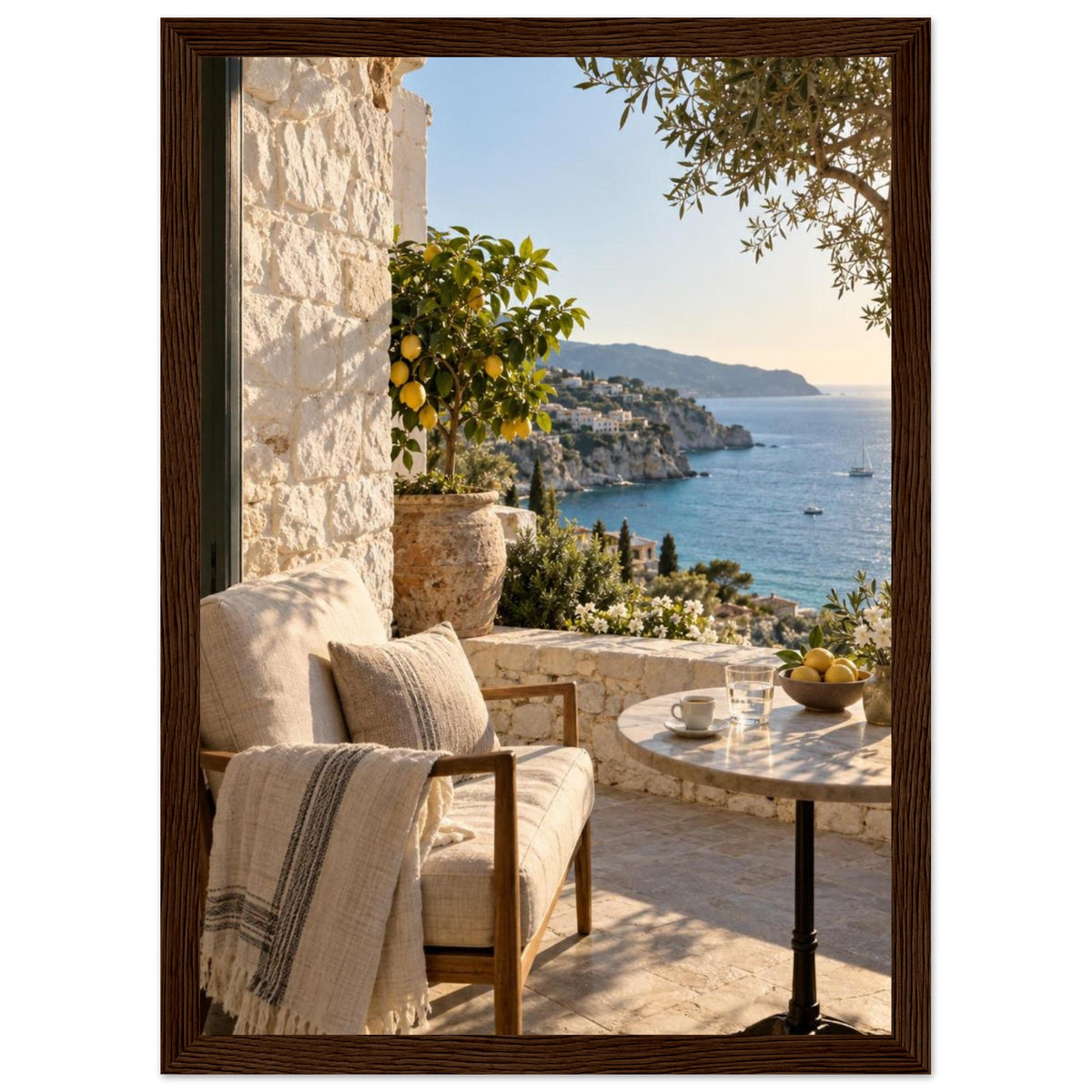 Lemon tree on a stone terrace with a cushioned chair, round table and blue sea overlooking a rocky coastline.