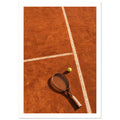 Tennis racket and yellow-green ball on an orange clay court, with white lines, footprints and strong shadows.