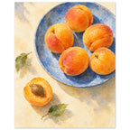 Apricots on a blue plate painted in watercolour, with a halved fruit beside the plate on a buttery cream tabletop.