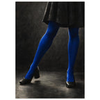 Cobalt Stockings, cropped legs in blue tights and black shoes forming an angular pose against a charcoal studio background.