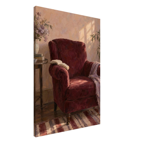 Burgundy armchair with an open book and lilac throw beside a table with flowers, books and a cup in a sunlit room.