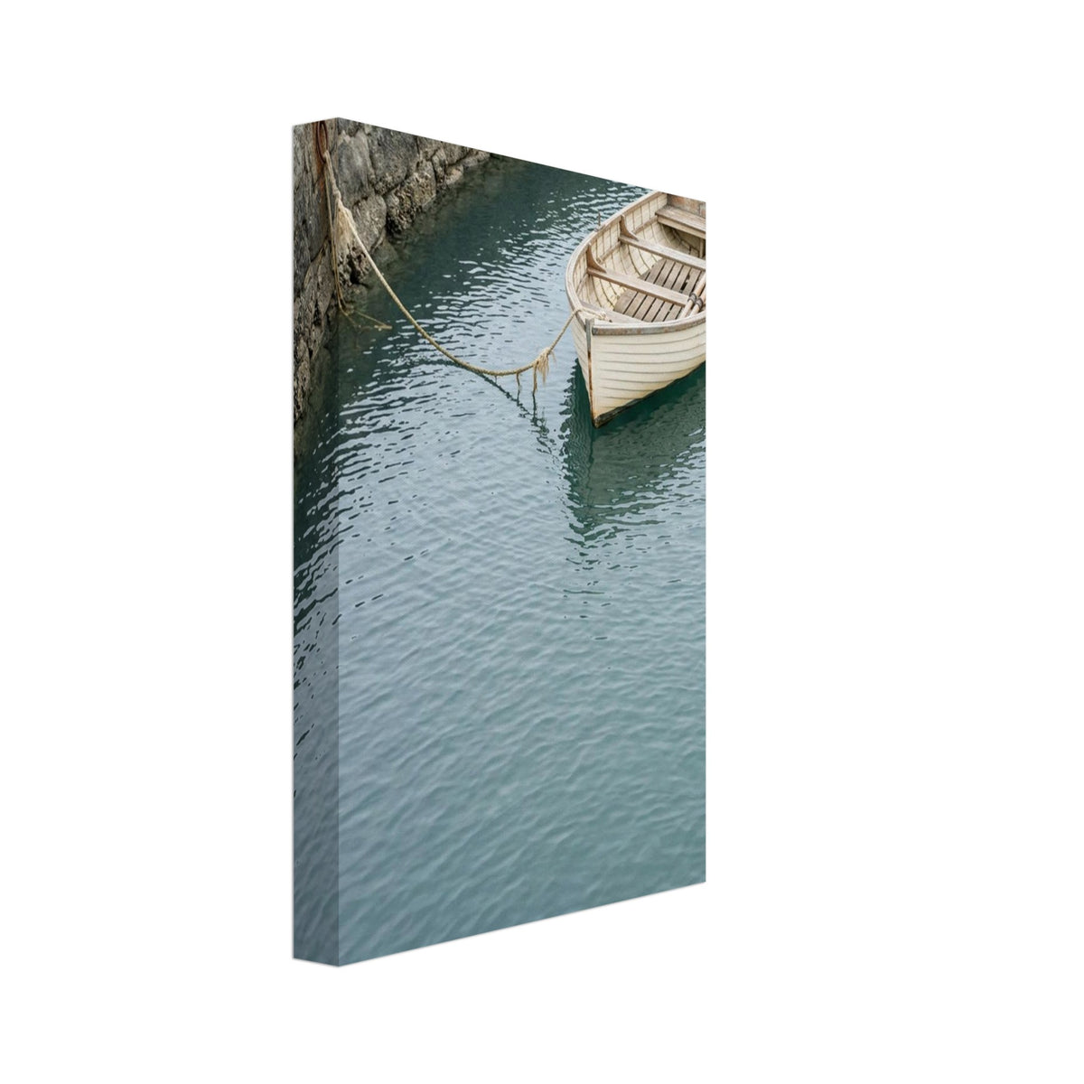 Cream wooden rowboat with oars, tied to a stone harbour wall above gently rippling blue-green water.