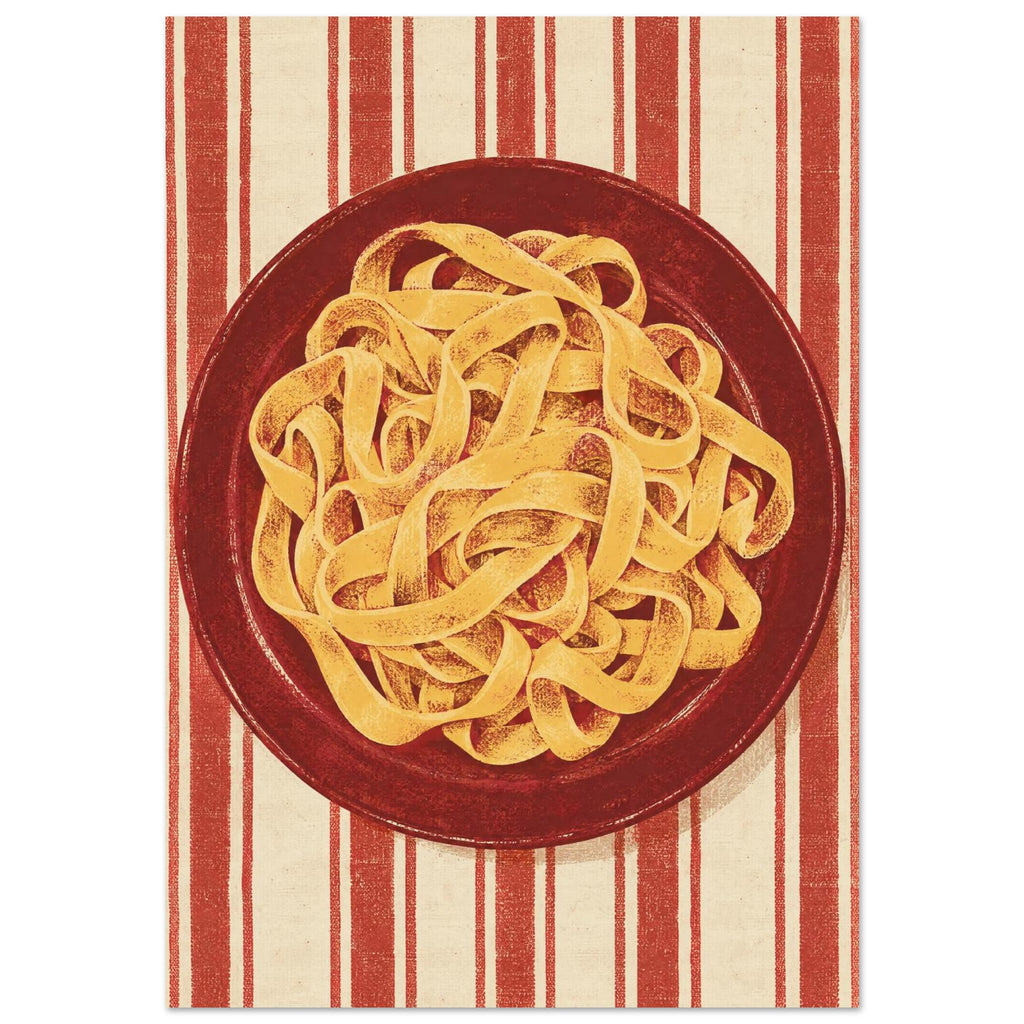 Golden pasta ribbons on a deep red plate, viewed from above against textured red and cream vertical stripes.